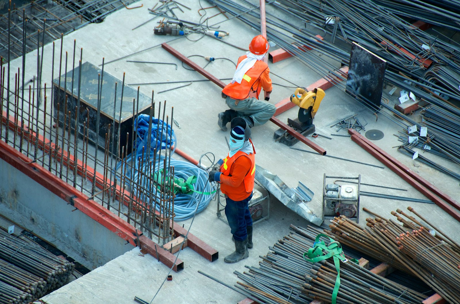 Construction workers handling materials on an active project site